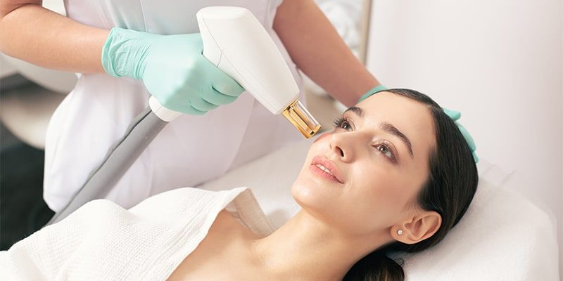 a woman receiving a laser treatment